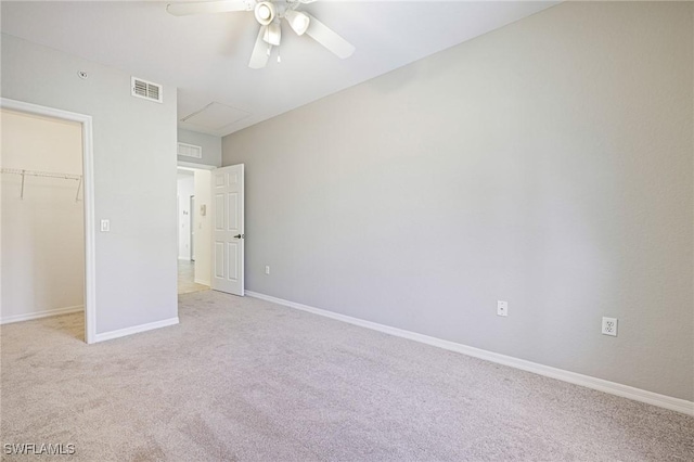 20273 Royal Villagio Ct Unit 204, Estero, FL 33928 - unfurnished bedroom with light carpet, a spacious closet, baseboards, a ceiling fan, and a closet