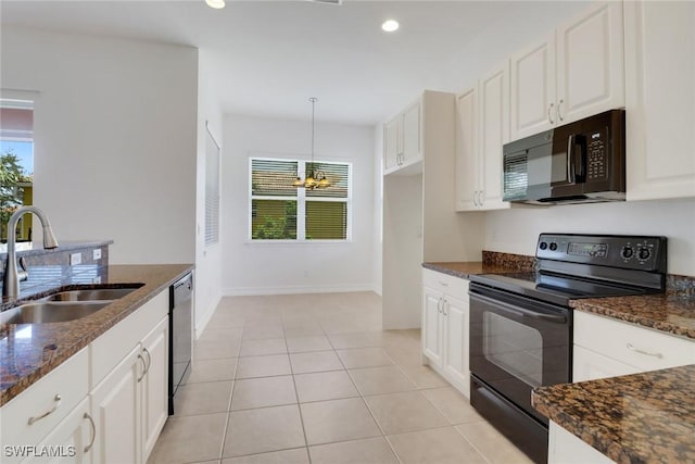 kitchen with black appliances, a sink, dark stone counters, white cabinetry, and recessed lighting
