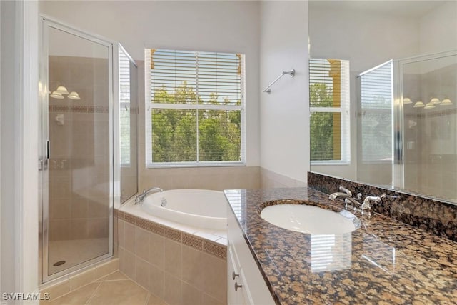 bathroom with a shower stall, tile patterned floors, vanity, and a bath
