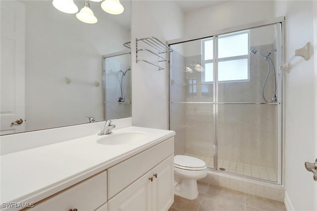full bath with a stall shower, vanity, toilet, and tile patterned flooring