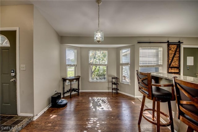 2532 SW 12th Pl, Cape Coral, FL 33914 - dining room featuring hardwood / wood-style flooring, baseboards, and a barn door