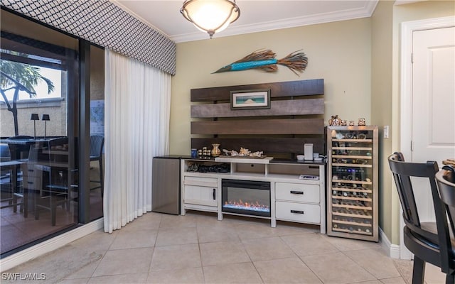 5704 Cape Harbour Dr Unit 105, Cape Coral, FL 33914 - bar area featuring wine cooler, crown molding, light tile patterned floors, a glass covered fireplace, and baseboards