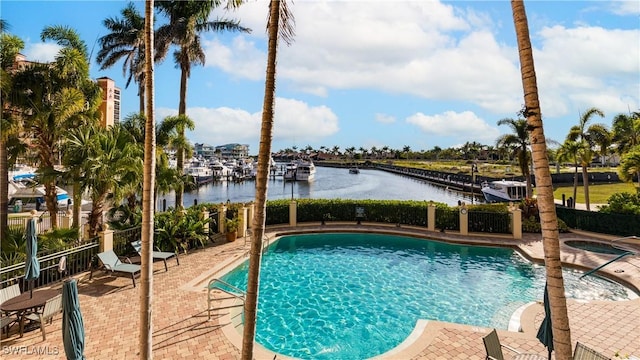 5704 Cape Harbour Dr Unit 105, Cape Coral, FL 33914 - community pool with a water view, a hot tub, and a patio area