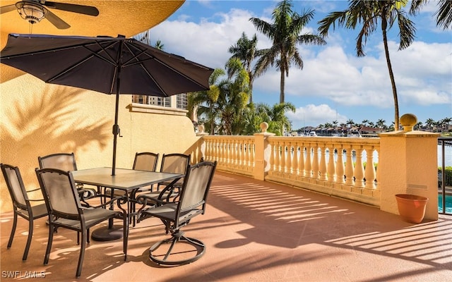 5704 Cape Harbour Dr Unit 105, Cape Coral, FL 33914 - wooden terrace featuring outdoor dining area and a ceiling fan