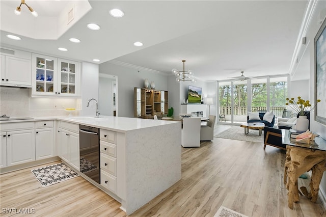 2728 Tiburon Blvd E Unit A104, Naples, FL 34109 - kitchen featuring dishwashing machine, a sink, a peninsula, open floor plan, and crown molding