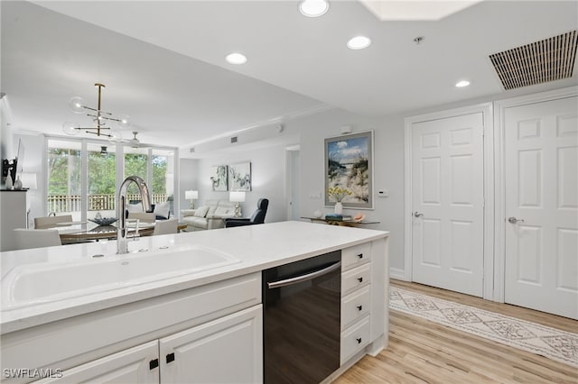 2728 Tiburon Blvd E Unit A104, Naples, FL 34109 - kitchen featuring dishwashing machine, a sink, light wood-style flooring, white cabinets, and recessed lighting