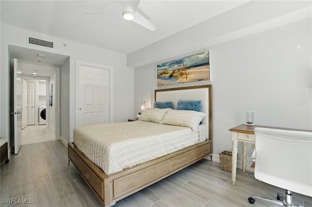 2728 Tiburon Blvd E Unit A104, Naples, FL 34109 - bedroom with light wood-style flooring, washer / dryer, ceiling fan, and baseboards