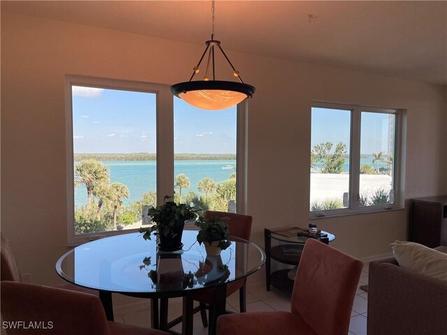 8751 Estero Blvd W Unit 304, Bonita Springs, FL 33931 - dining room with light tile patterned floors, healthy amount of natural light, and a water view