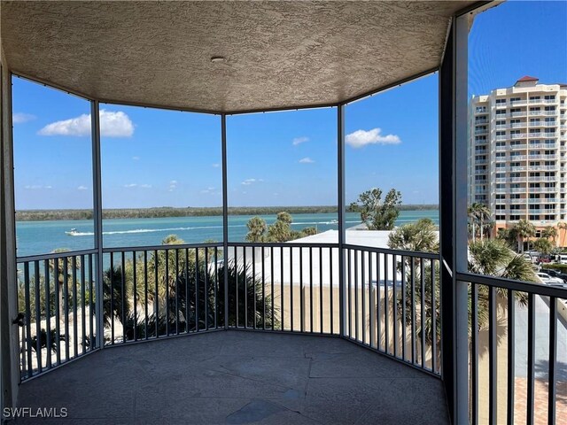 8751 Estero Blvd W Unit 304, Bonita Springs, FL 33931 - unfurnished sunroom featuring a water view