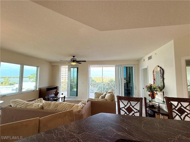 8751 Estero Blvd W Unit 304, Bonita Springs, FL 33931 - dining room with a ceiling fan and a textured ceiling
