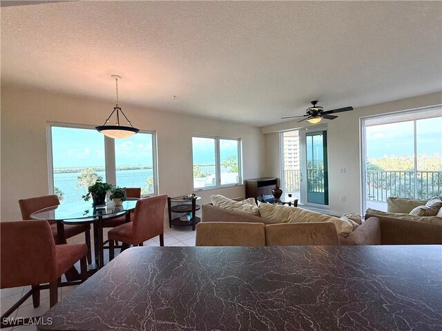 8751 Estero Blvd W Unit 304, Bonita Springs, FL 33931 - dining space with ceiling fan, light tile patterned flooring, and a textured ceiling