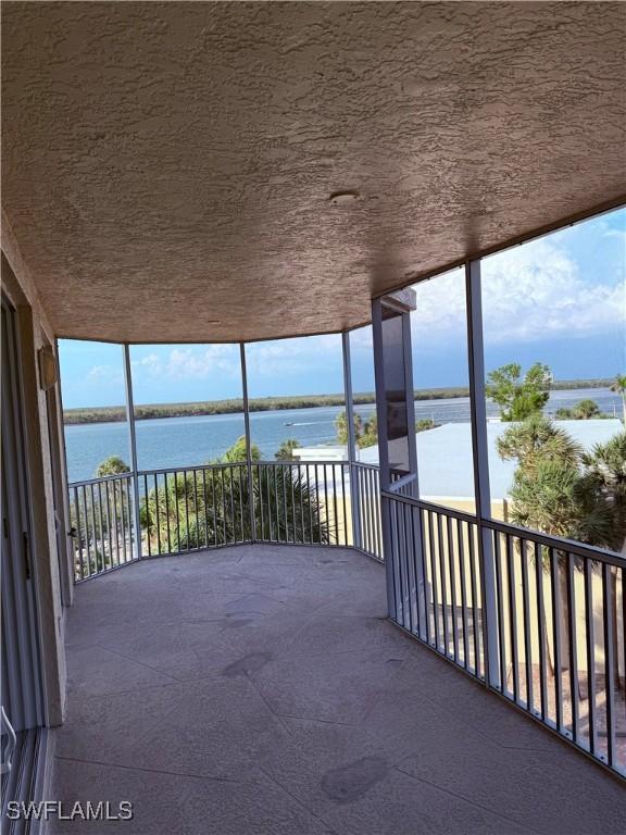 8751 Estero Blvd W Unit 304, Bonita Springs, FL 33931 - unfurnished sunroom featuring a water view and healthy amount of natural light