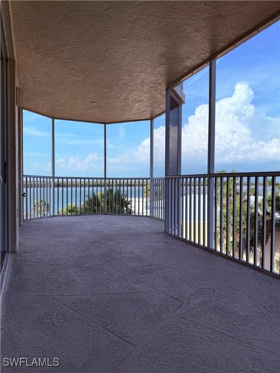 8751 Estero Blvd W Unit 304, Bonita Springs, FL 33931 - unfurnished sunroom with a water view