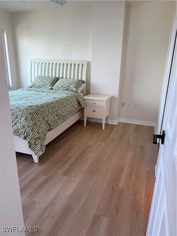 8751 Estero Blvd W Unit 304, Bonita Springs, FL 33931 - bedroom featuring light wood finished floors and baseboards