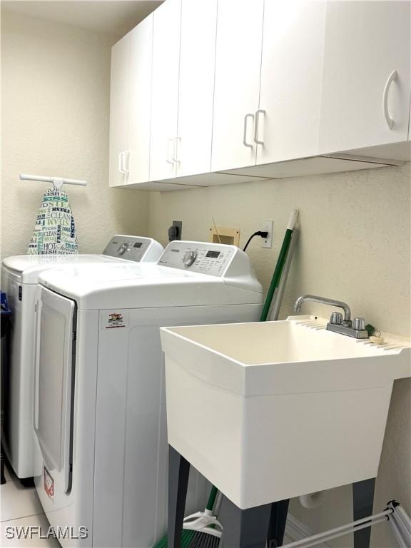 8751 Estero Blvd W Unit 304, Bonita Springs, FL 33931 - laundry room with washer and dryer and cabinet space