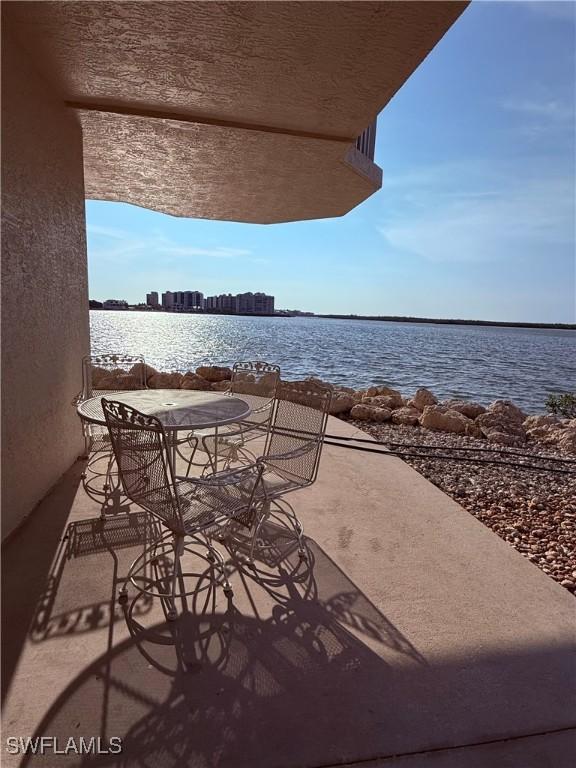 8751 Estero Blvd W Unit 304, Bonita Springs, FL 33931 - view of patio featuring a water view and outdoor dining space