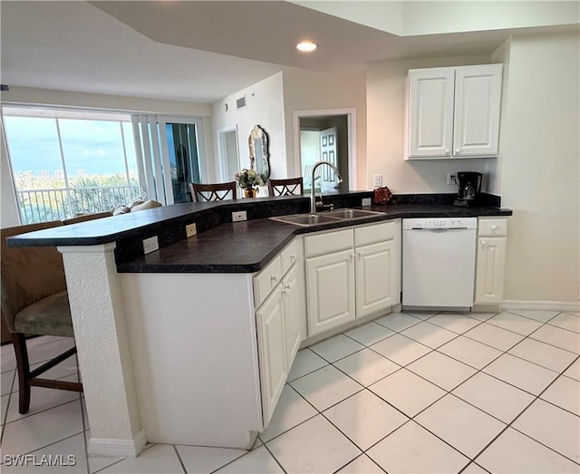 8751 Estero Blvd W Unit 304, Bonita Springs, FL 33931 - kitchen with dishwasher, a sink, a peninsula, a breakfast bar, and white cabinets