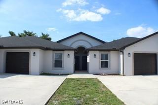 627 SE 13th Ter A-D, Unit A-D, Cape Coral, FL 33990 - ranch-style house featuring driveway, an attached garage, and stucco siding