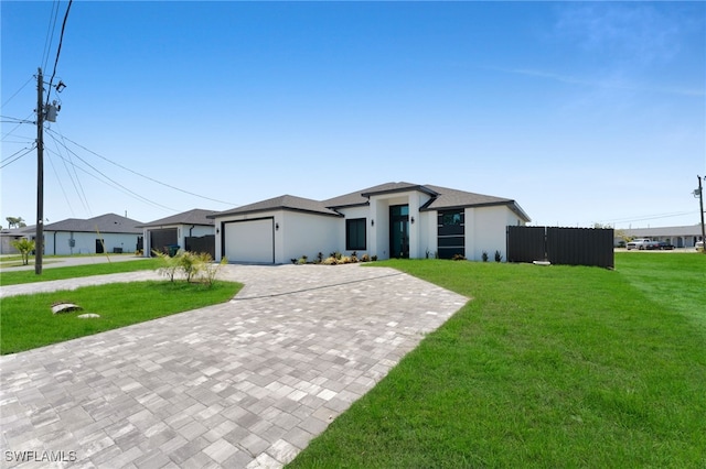 373 El Dorado Blvd S, Cape Coral, FL 33991 - view of front facade featuring decorative driveway, a front lawn, and a garage