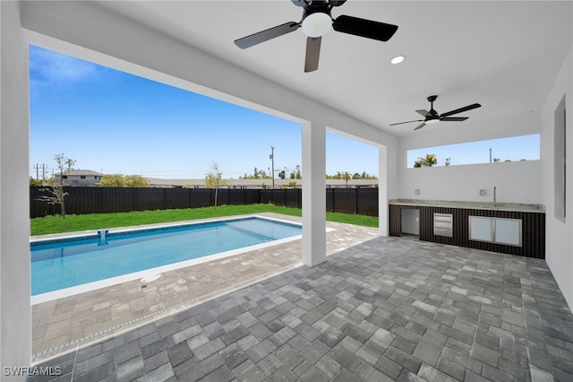 373 El Dorado Blvd S, Cape Coral, FL 33991 - view of pool with a ceiling fan, a patio area, a sink, and an outdoor kitchen