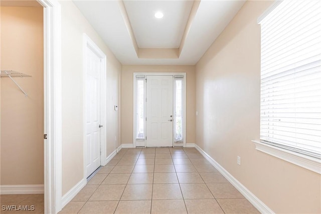 3905 Dunnster Ct, Fort Myers, FL 33916 - entrance foyer with light tile patterned floors, a tray ceiling, healthy amount of natural light, baseboards, and recessed lighting
