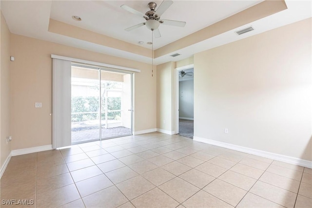 3905 Dunnster Ct, Fort Myers, FL 33916 - spare room featuring a tray ceiling, a ceiling fan, light tile patterned flooring, and baseboards