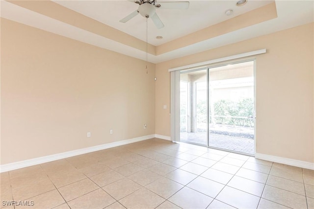 3905 Dunnster Ct, Fort Myers, FL 33916 - unfurnished room with light tile patterned floors, baseboards, a tray ceiling, and ceiling fan