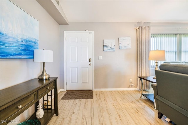 305 SW 8th St, Cape Coral, FL 33991 - foyer featuring light wood-style floors and baseboards