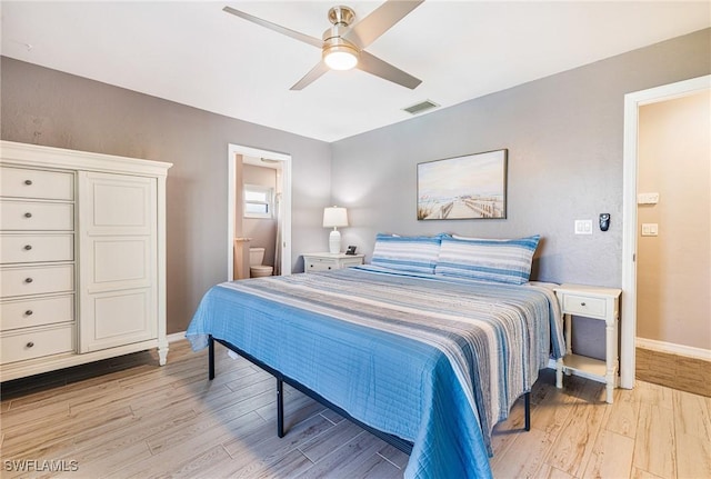 305 SW 8th St, Cape Coral, FL 33991 - bedroom featuring light wood-style flooring, baseboards, connected bathroom, and ceiling fan