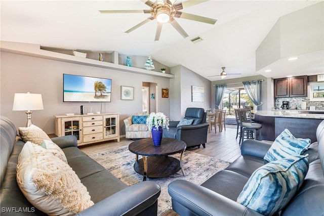 305 SW 8th St, Cape Coral, FL 33991 - living room featuring ceiling fan, vaulted ceiling, and light wood-style flooring
