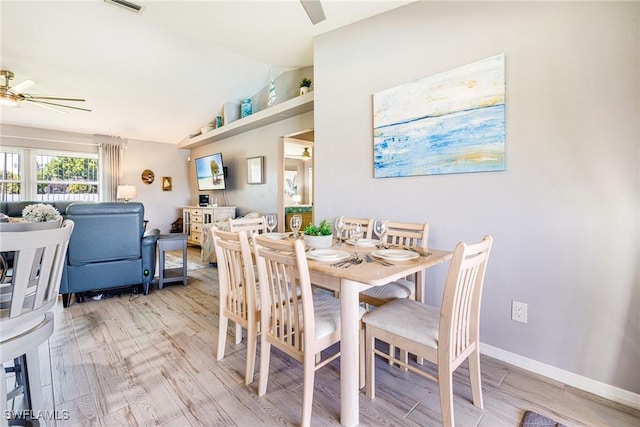 305 SW 8th St, Cape Coral, FL 33991 - dining room featuring ceiling fan, vaulted ceiling, light wood-style flooring, and baseboards