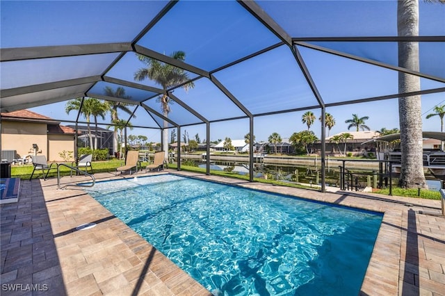 305 SW 8th St, Cape Coral, FL 33991 - swimming pool featuring a patio, a water view, and glass enclosure