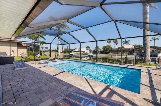 305 SW 8th St, Cape Coral, FL 33991 - outdoor pool with a patio area, glass enclosure, and a residential view