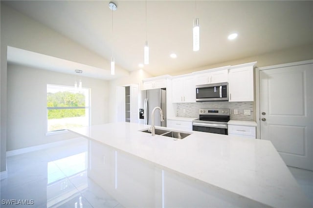 1962 Leghorn St, Lehigh Acres, FL 33972 - kitchen with stainless steel appliances, a sink, tasteful backsplash, white cabinets, and an island with sink