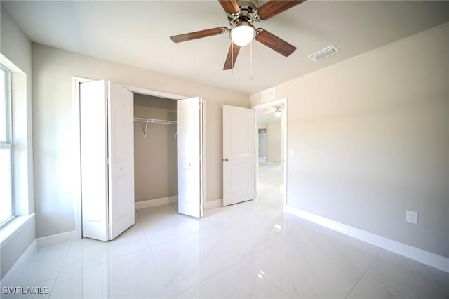1962 Leghorn St, Lehigh Acres, FL 33972 - unfurnished bedroom featuring baseboards, a closet, a ceiling fan, and light tile patterned floors
