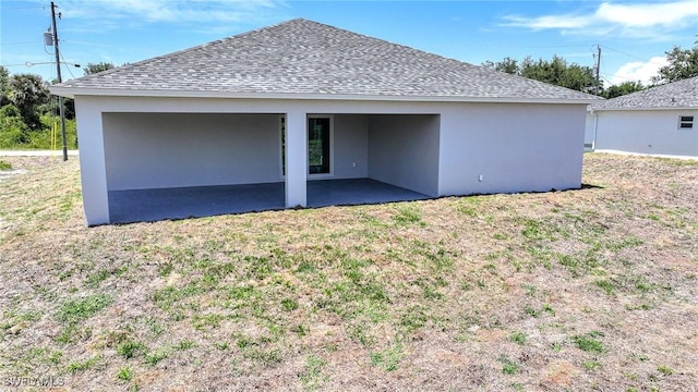 1962 Leghorn St, Lehigh Acres, FL 33972 - back of property with a patio, a yard, a shingled roof, and stucco siding