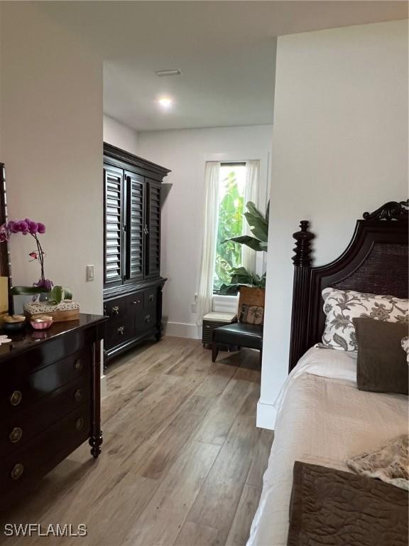 548 5th Ave, Marco Island, FL 34145 - bedroom with light wood-style flooring and baseboards