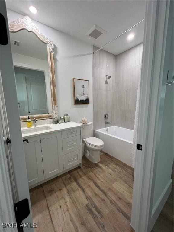 548 5th Ave, Marco Island, FL 34145 - bathroom with toilet, vanity, bathing tub / shower combination, wood finished floors, and recessed lighting