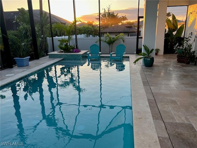 548 5th Ave, Marco Island, FL 34145 - pool at dusk featuring a patio area and fence
