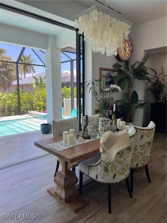 548 5th Ave, Marco Island, FL 34145 - dining room featuring healthy amount of natural light, a sunroom, and wood finished floors