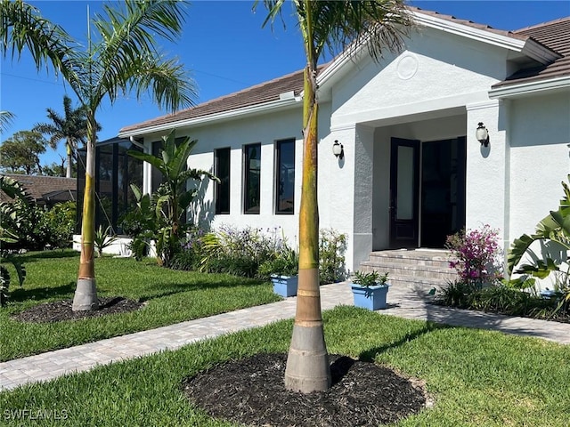 548 5th Ave, Marco Island, FL 34145 - view of front facade featuring stucco siding and a front yard