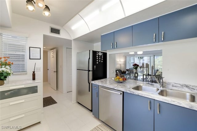 129 S Collier Blvd Unit B-206, Marco Island, FL 34145 - kitchen featuring blue cabinetry, appliances with stainless steel finishes, a sink, lofted ceiling, and light flooring
