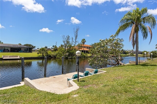 132 SW 34th Ln, Cape Coral, FL 33914 - dock area with a lawn and a water view