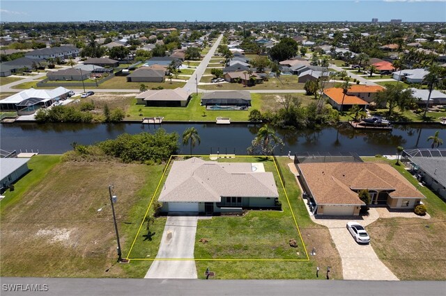 132 SW 34th Ln, Cape Coral, FL 33914 - aerial perspective of suburban area featuring a large body of water and property boundaries highlighted