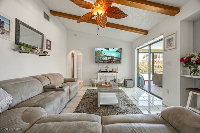 132 SW 34th Ln, Cape Coral, FL 33914 - living room featuring arched walkways, a ceiling fan, light tile patterned floors, and a textured ceiling