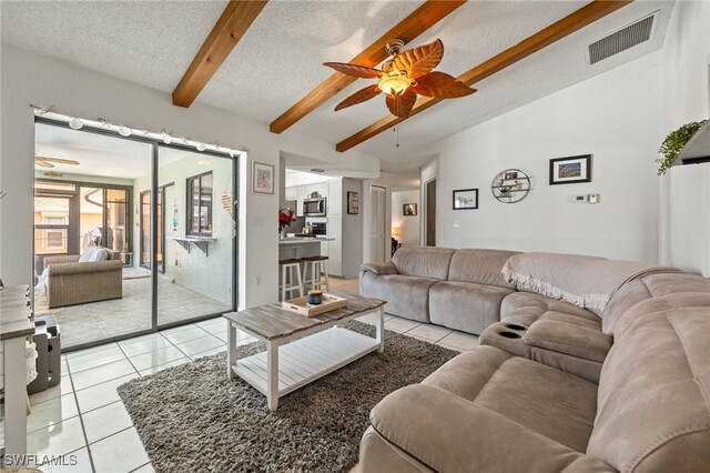 132 SW 34th Ln, Cape Coral, FL 33914 - living room with a ceiling fan, light tile patterned floors, and a textured ceiling