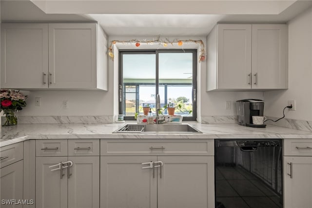 132 SW 34th Ln, Cape Coral, FL 33914 - kitchen with black dishwasher, a sink, and white cabinetry