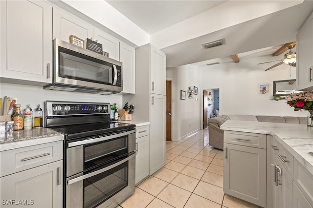 132 SW 34th Ln, Cape Coral, FL 33914 - kitchen featuring appliances with stainless steel finishes, ceiling fan, open floor plan, light tile patterned floors, and light stone counters
