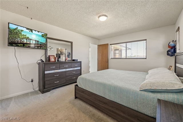 132 SW 34th Ln, Cape Coral, FL 33914 - carpeted bedroom with a textured ceiling and baseboards