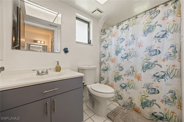 132 SW 34th Ln, Cape Coral, FL 33914 - bathroom featuring tile patterned floors, toilet, vanity, and a shower with shower curtain